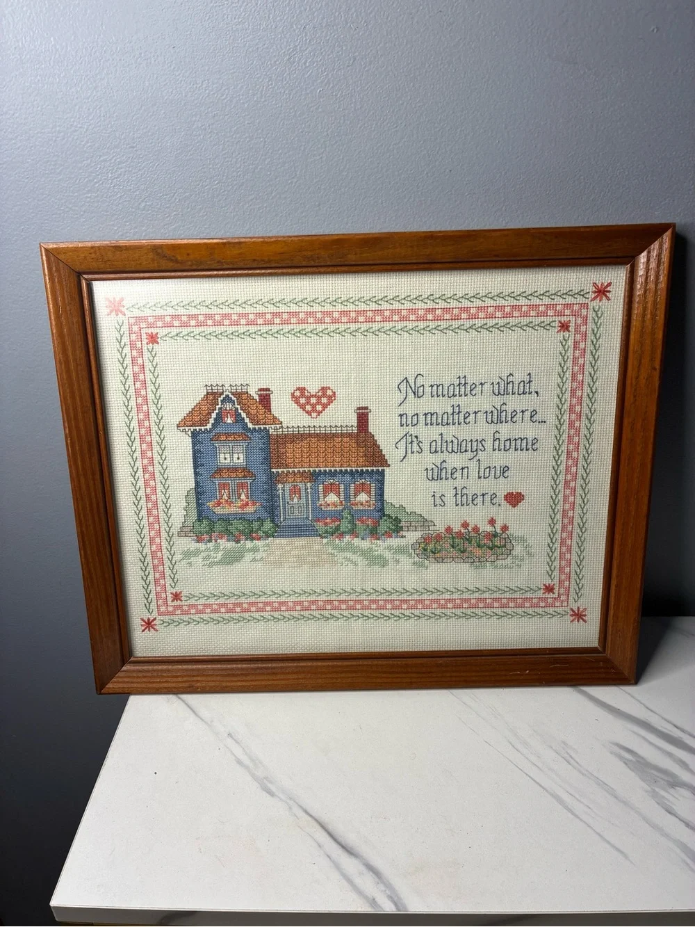 Framed Cross Stitch Home Sampler with Blue House and Quote